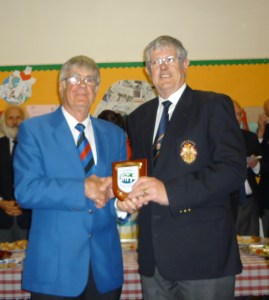 President Jim Evans presenting the president of Launceston MVC with a BMVC Shield to commemorate the Choir's visit May 2015 